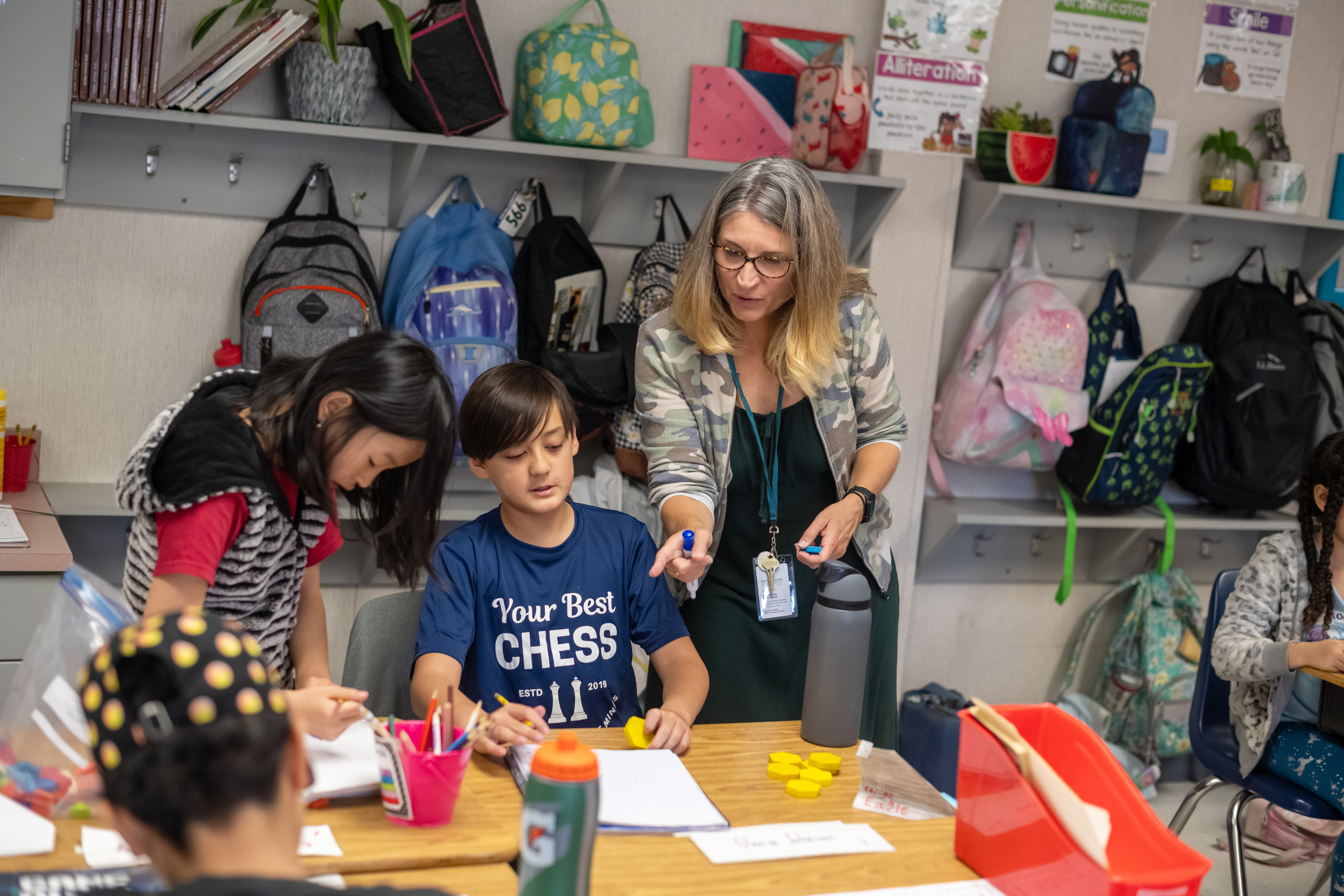 Teacher working with two students